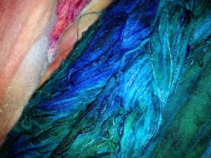 Two different warp chains, and matching wool roving dyed in the same lot.