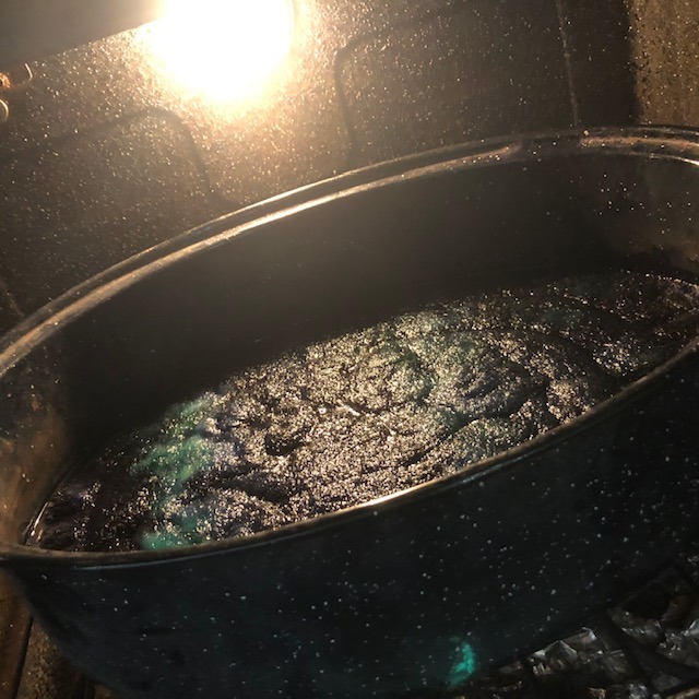 wet wool roving in a pan cooking in the oven to set the dye